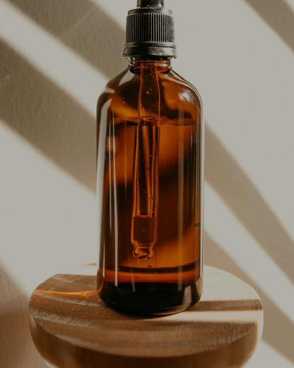 Body oil bottle catching low afternoon light