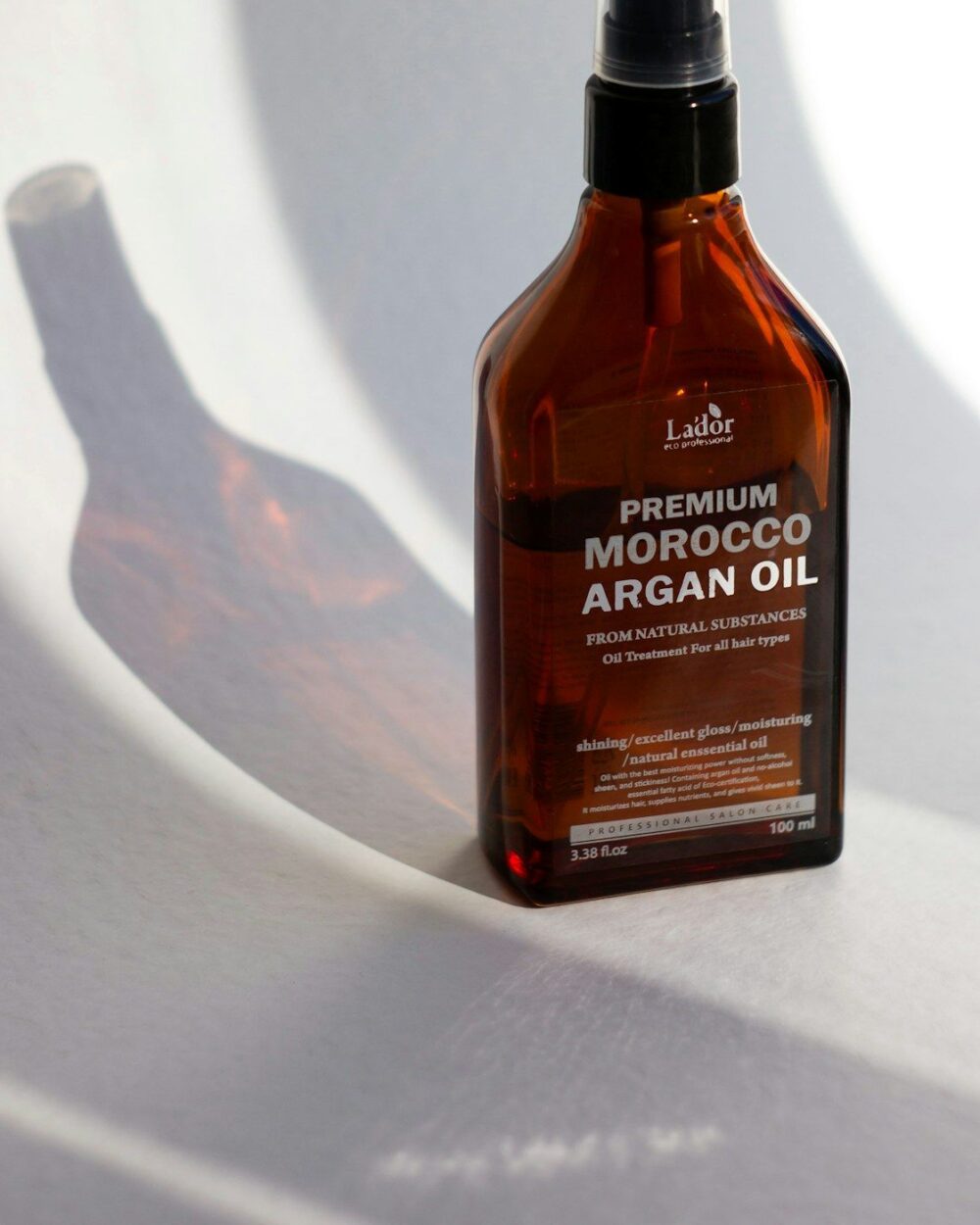 Amber hair oil bottle in soft daylight