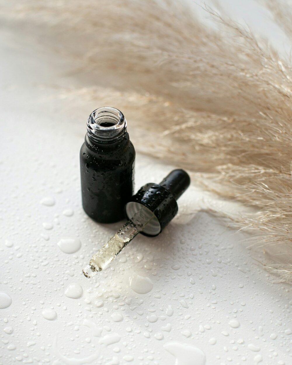 Dropper bottle laid on dried pampas grass